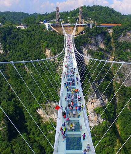 Traditional suspension bridge over Maa Ganga river in Rishikesh with mountain backdrop